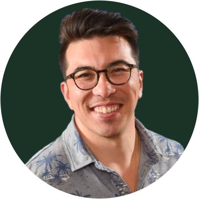 Ken Jee, smiling, in glasses and a palm-print shirt